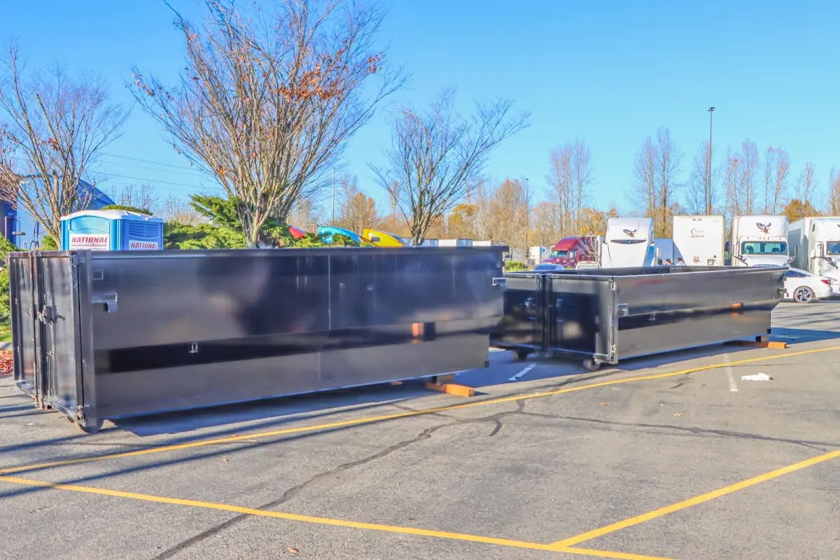 Professional dumpster rental service with roll-off container on residential driveway in Lufkin